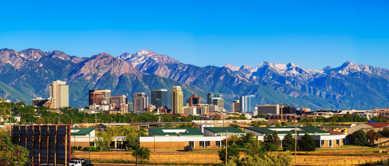 Skyline of Salt Lake City downtown in Utah with Wasatch Range Mountains in the background.