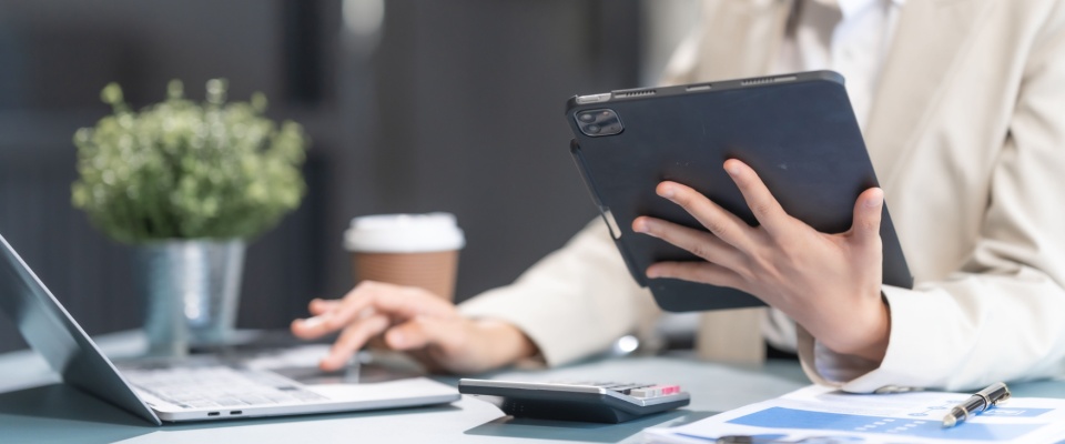 A proficient businesswoman working confidently at her desk, specializing in credit management. The scene highlights her expertise in financial analysis, credit evaluation, and professional problem-solving in a modern office setting.