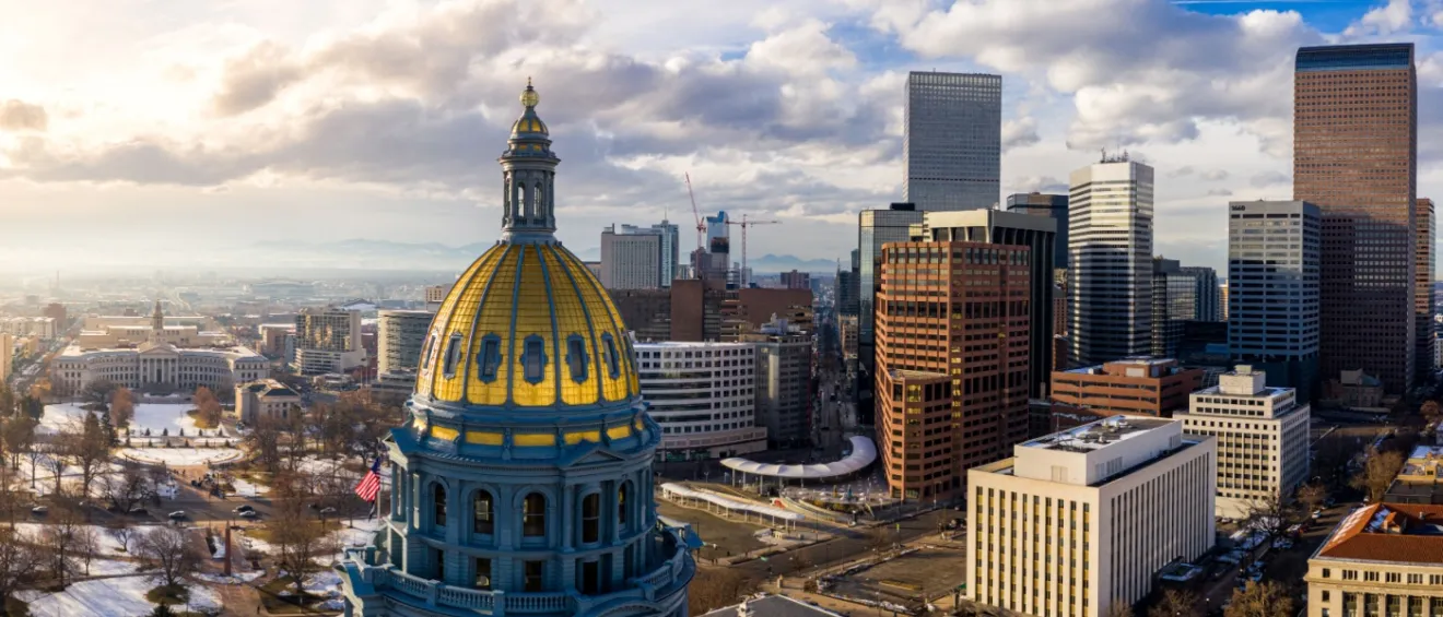 Colorado State Capitol Building & the City of Denver Colorado at Sunset. Rocky Mountains on the Horizon. Find affordable neighborhoods in Denver, CO.