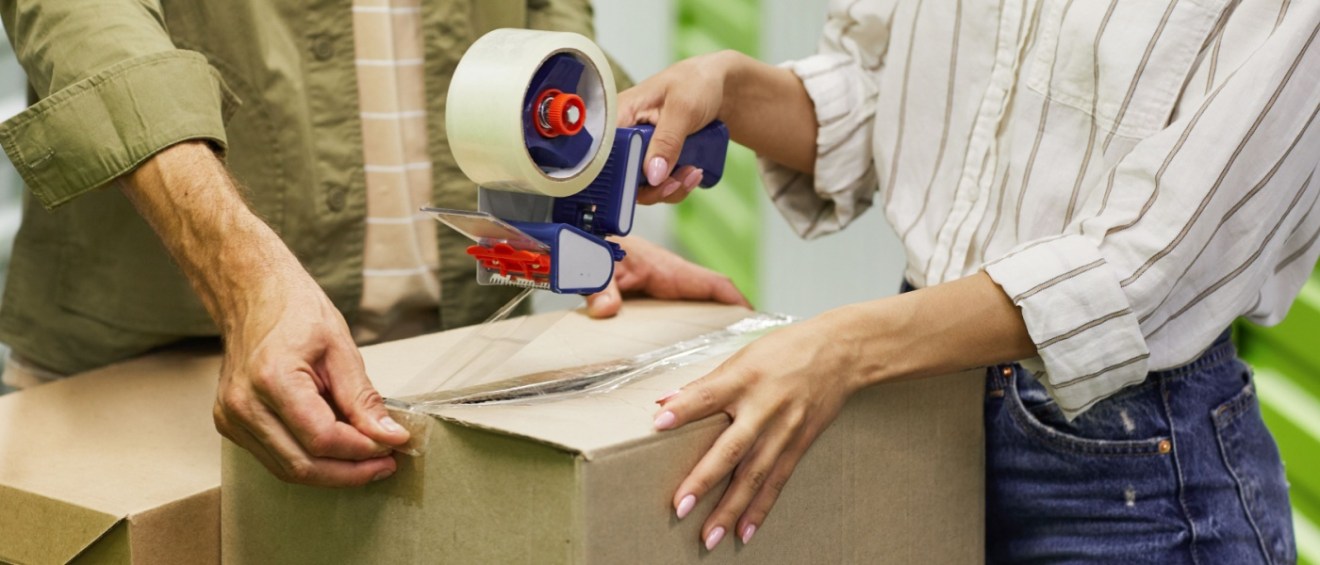 Couple holding cardboard box.