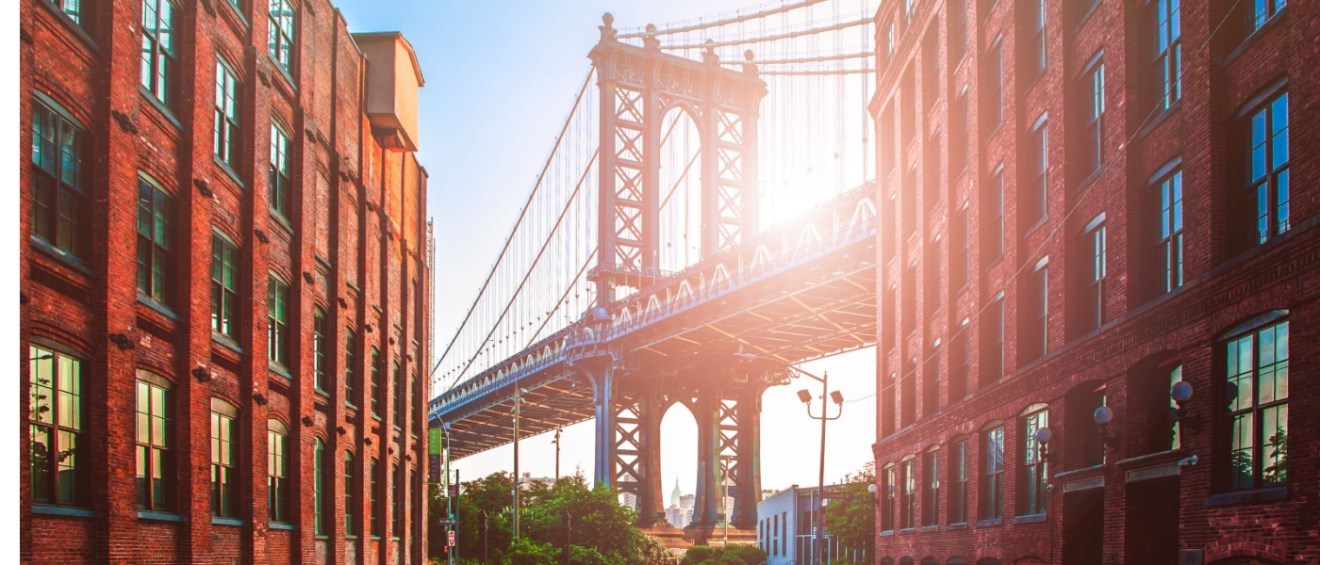 A view of Brooklyn's iconic Brooklyn Bridge with affordable neighborhoods in the foreground, perfect for New Yorkers on a budget.