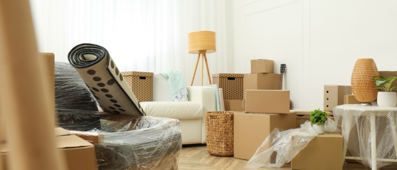 A room full of boxes and packed things, ready for moving.