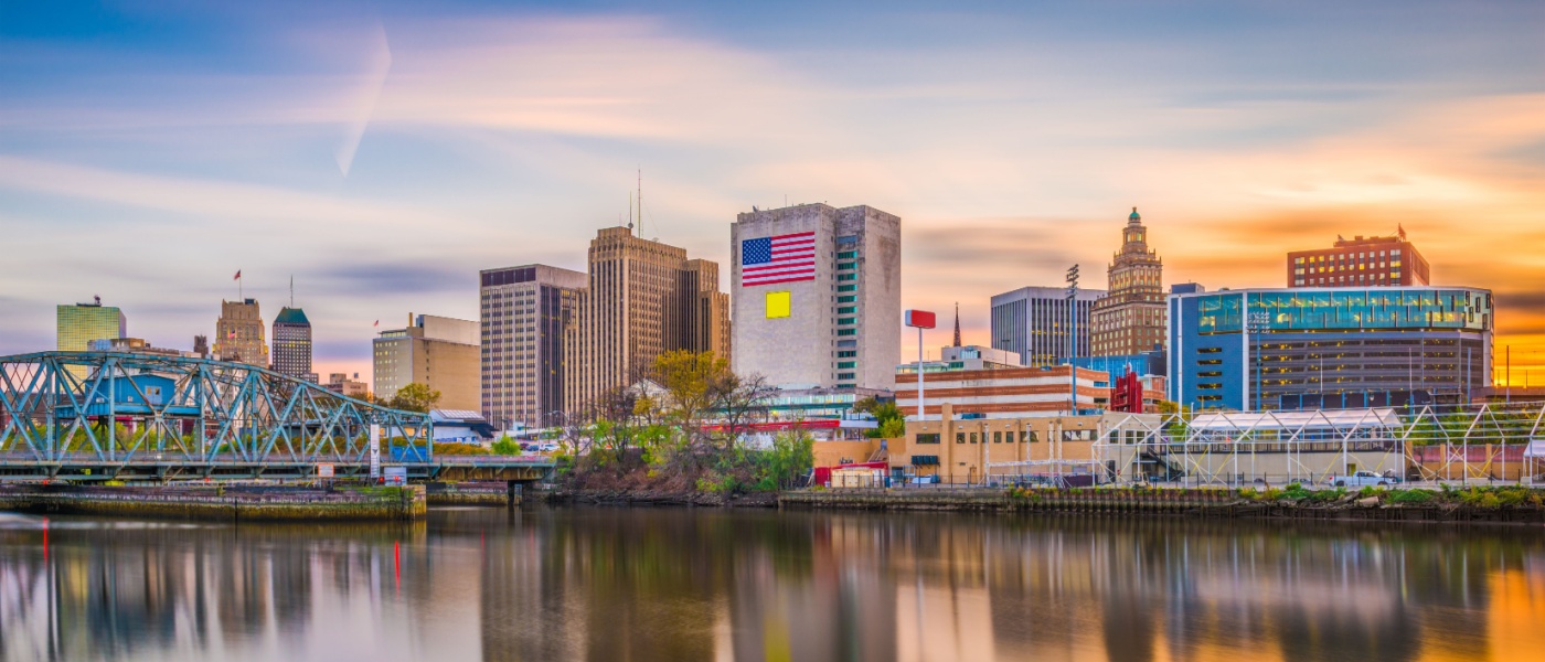 Newark, NJ, skyline at sunset, showcasing the city's mix of historic and modern buildings — an appealing destination for renters looking for affordable neighborhoods.