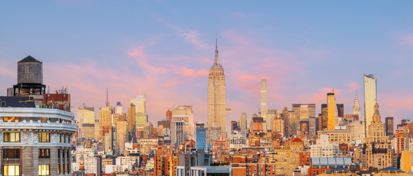 Sunset view of Midtown Manhattan’s skyline, highlighting the challenge of finding affordable neighborhoods in the heart of New York City.