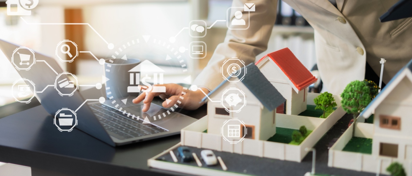 Person using a laptop with digital icons over model houses, symbolizing the rental application approval process.