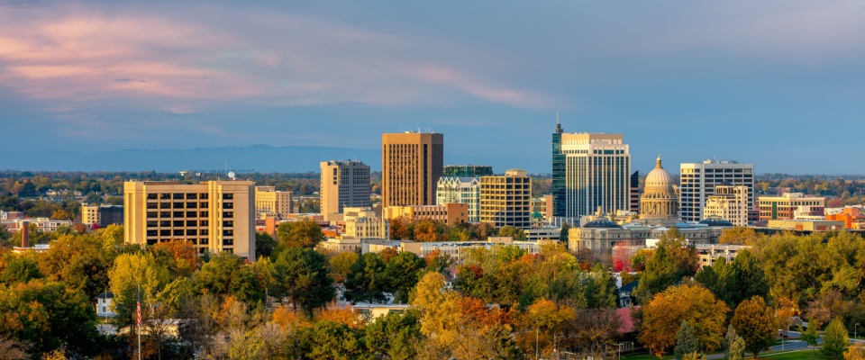 The Boise, ID, skyline rises above colorful fall trees, representing the #7 ranked US metro for renter mobility.
