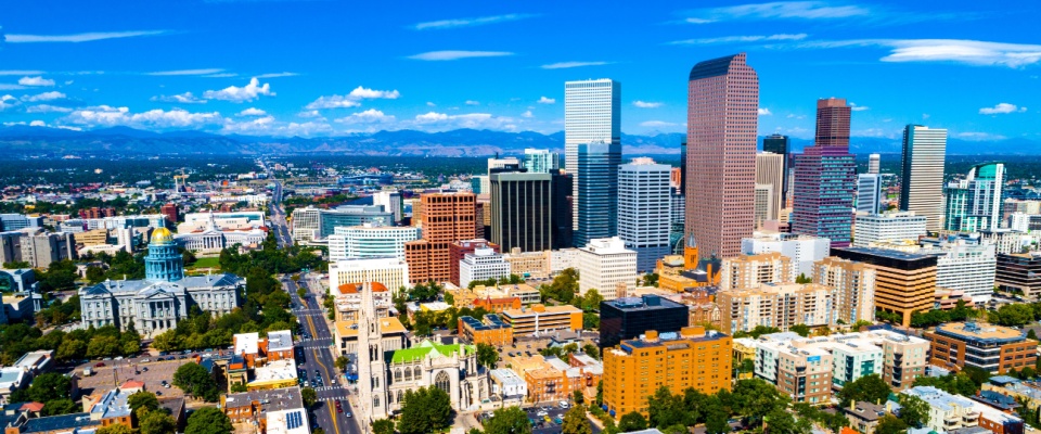 Sunny Denver, CO skyline with the Capitol dome and mountains, ranked #5 US move-easy metro for renters.