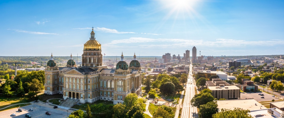 Sunny view of Des Moines, IA featuring the State Capitol and downtown skyline. Des Moines is the #10 move-easy metro for renters.