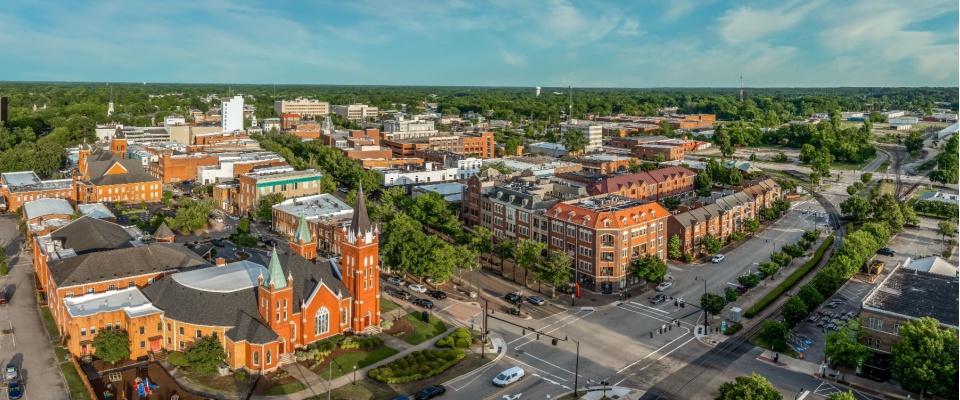 Daytime aerial view over downtown Fayetteville, AR, ranked the #4 US move-easy metro for frequent renters.