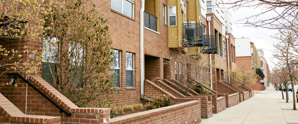 Row of modern brick apartment buildings in Denver, illustrating the types of residential rentals to consider when asking key questions before signing a lease.