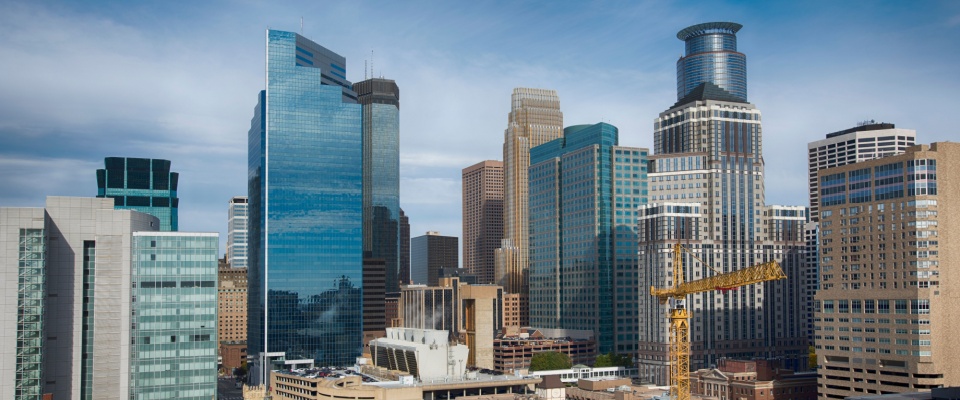 A shot of the skyline in downtown Minneapolis with a construction crane among the towering skyscrapers.