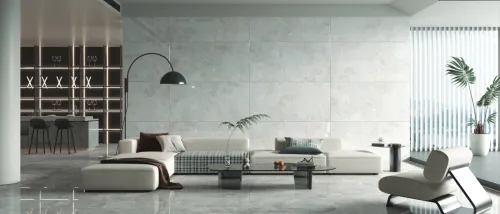 Luxury studio apartment interior design with cozy sofa set with grey rug on it, white wall, grey marble floor, office corner with desk and chair and laptop, illustrating how much apartment space you can get for $1,500.