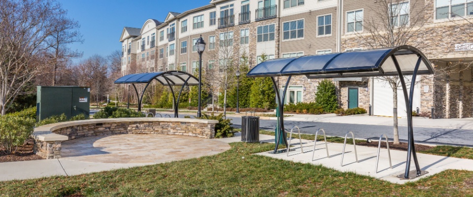 Outdoor bike storage area at a modern apartment complex, emphasizing the importance of asking about secure bike storage before renting an apartment in Denver.