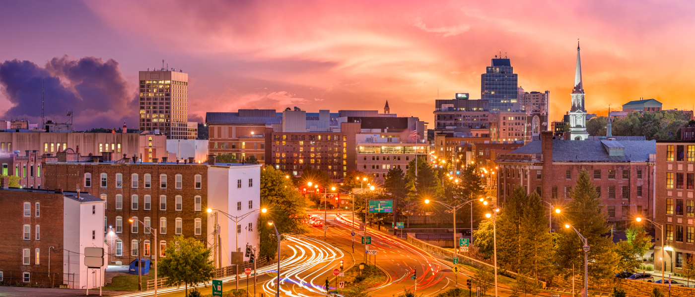 A shot of downtown Worcester, MA, pictured at dusk, a city with affordable neighborhoods where renters can find apartments for less than the local average.