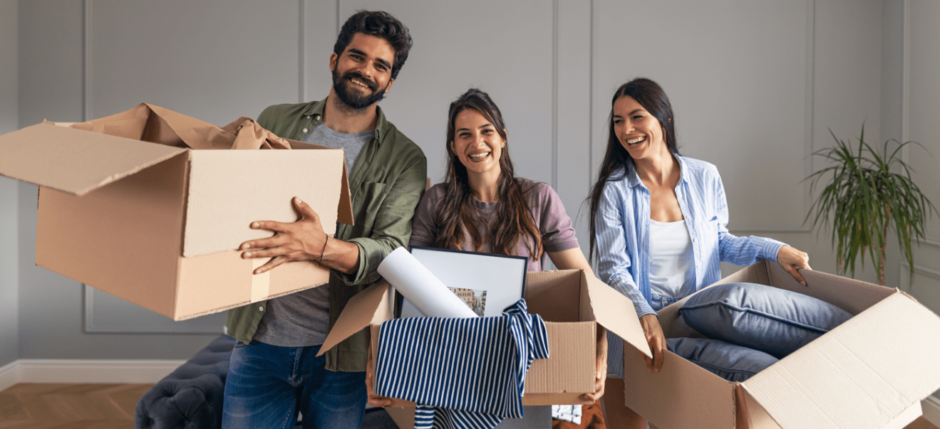 roommates moving together with boxes