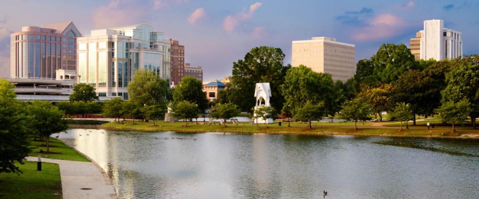 Cityscape scene of downtown Huntsville, Alabama, from Big Spring Park at sunset to illustrate the cost of living in Huntsville.