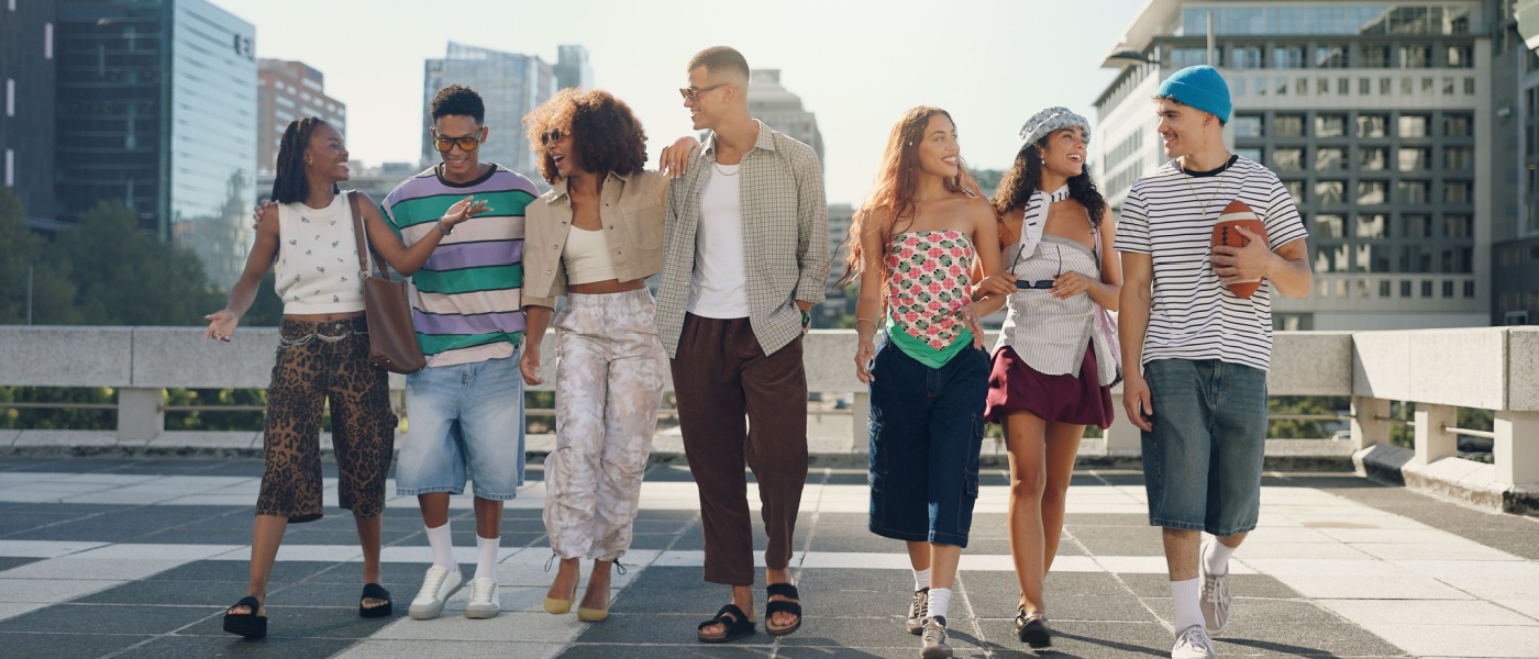 A group of Gen Z renters walking in the city with buildings in the background.
