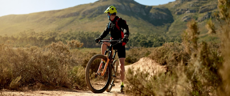 A cyclist riding along a rugged gravel path for a fitness challenge or outdoor training session showcases the active lifestyle options available near many apartments in Atlanta, ideal for residents who enjoy nature and recreational sports.