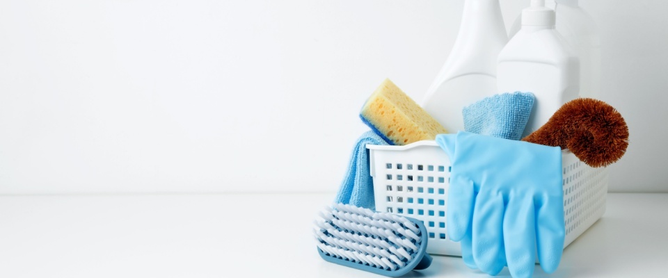 A container filled with cleaning supplies, prepared for a thorough home clean — perfect for a spring refresh or completing the move-out procedure.