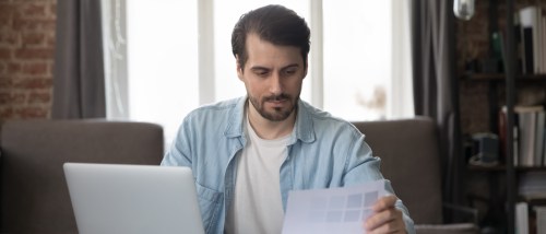 A person using a laptop to learn how to cancel an apartment application.