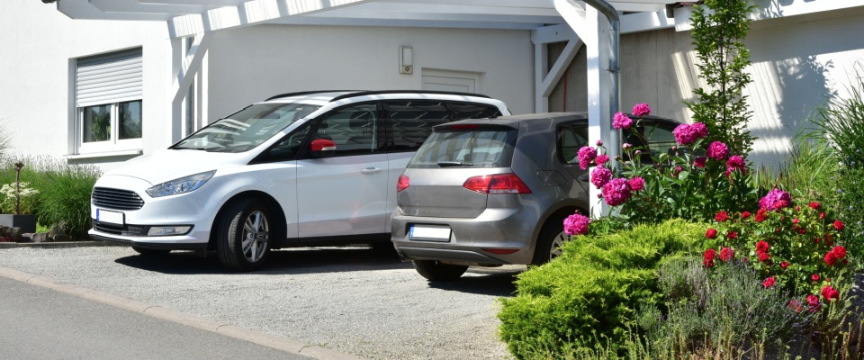 A new wooden carport built in front of a residential building — a common feature that can raise parking questions for residents.
