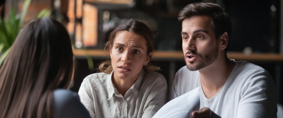 Renting couple disputing what counts as normal wear and tear with their landlord.