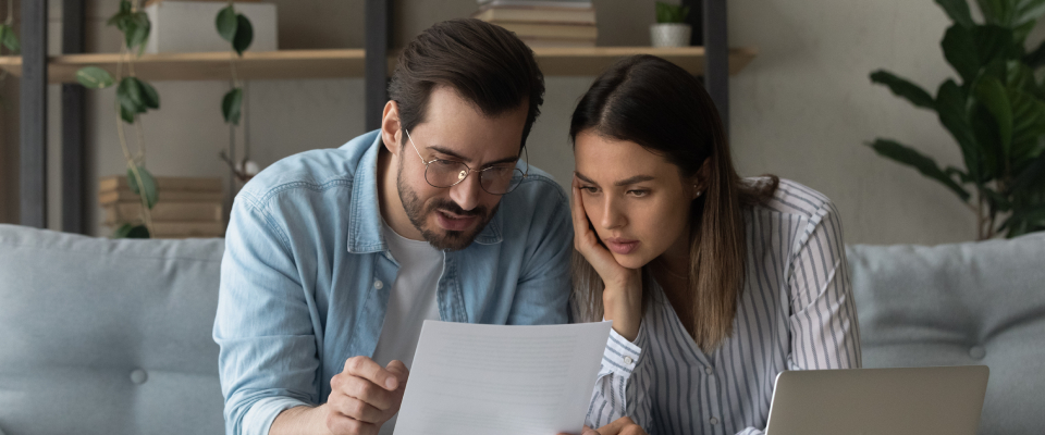A couple looking over their renewal notice.