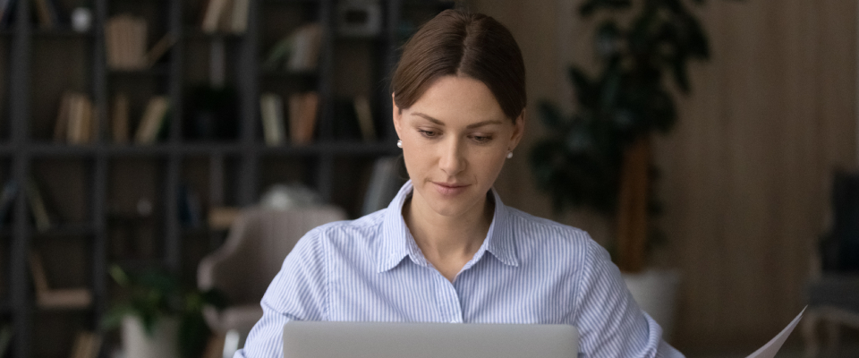 A woman using her laptop to look up "what is a renewal notice?"