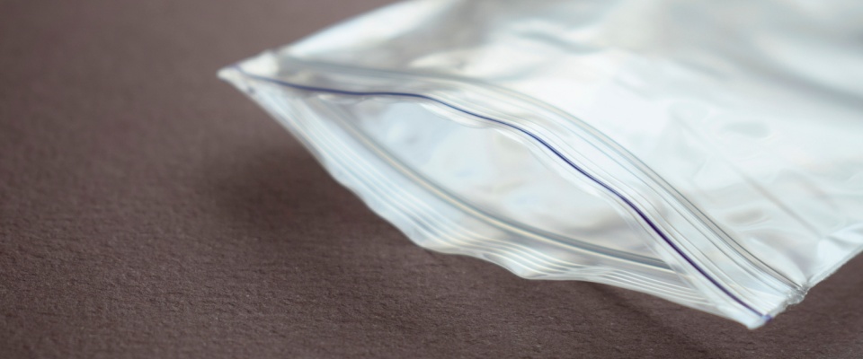 An open small transparent plastic bag with a zip clasp — a simple yet effective packing hack for organizing and protecting small items during a move or trip.