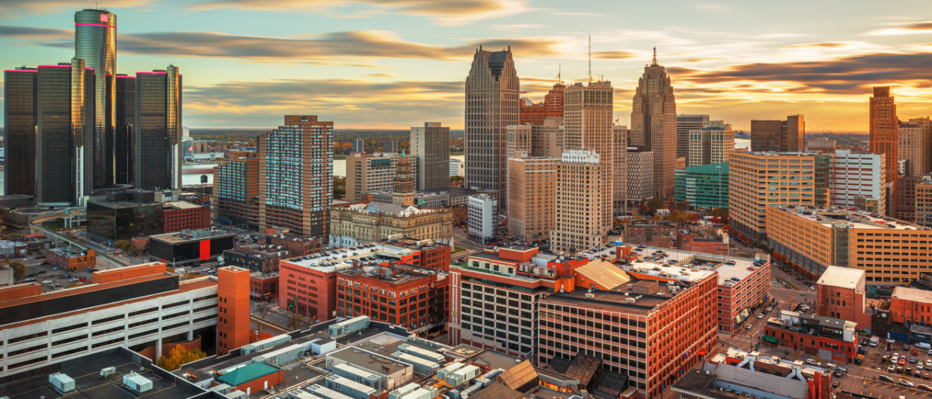 Detroit skyline at sunset with downtown apartments and neighborhoods, a guide for renters asking key questions before renting in Detroit.
