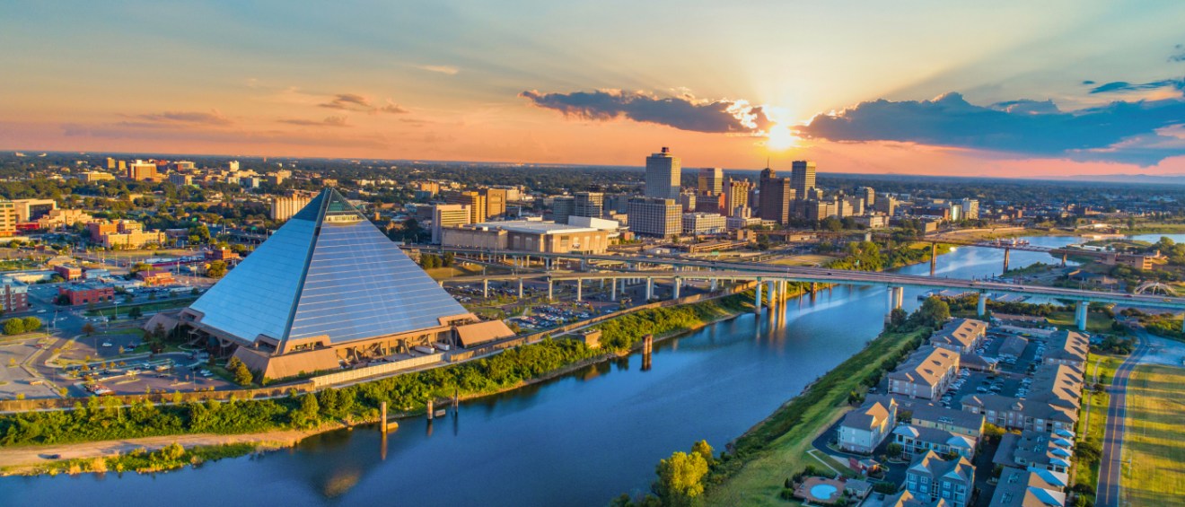 An aerial shot of the Mississippi River and the skyline in Memphis, TN, a city where the cost of living is below the state and national averages.