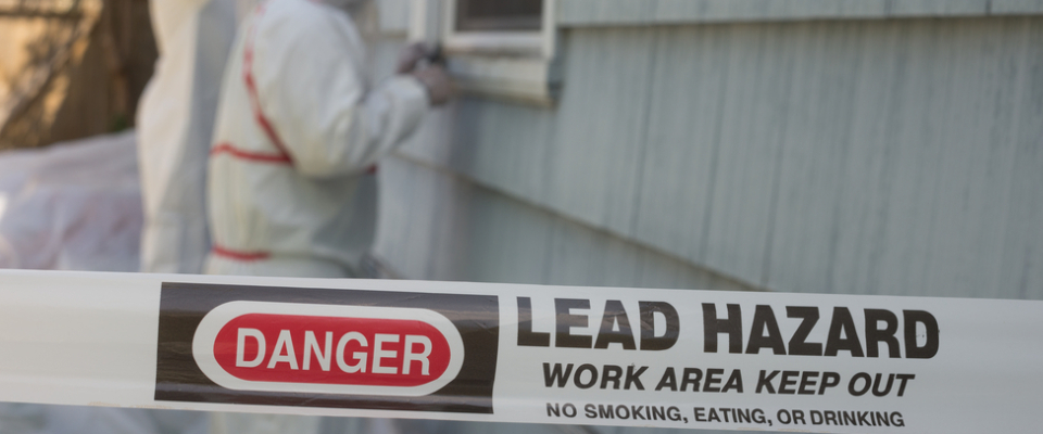 Warning tape marking a lead hazard during home inspection, illustrating the importance of lead-based paint disclosure for renters in older properties.