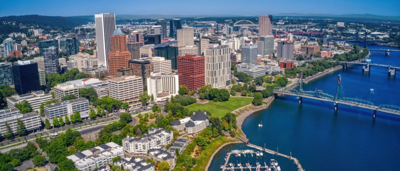 An aerial view of Portland, OR, during autumn showcases the city’s colors, unique skyline, and thriving urban growth, making it an attractive destination for those searching for new apartments in Portland.