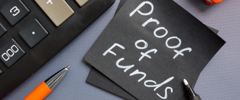 Close-up of a note reading ‘Proof of Funds’ next to a calculator and pen, symbolizing financial documents needed for renting or apartment hunting.