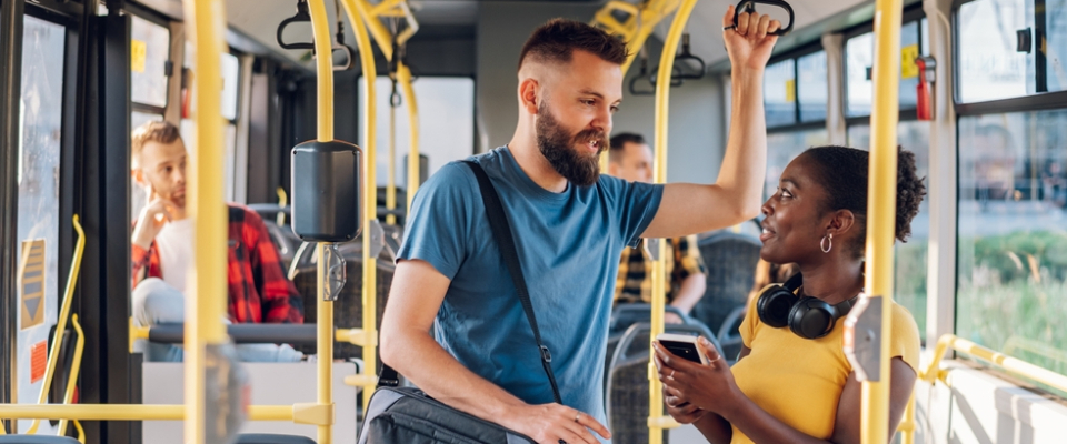 Young renters riding a SMART bus in Detroit, showing how public transit in Detroit connects city neighborhoods with nearby suburbs for work, school, and daily life.
