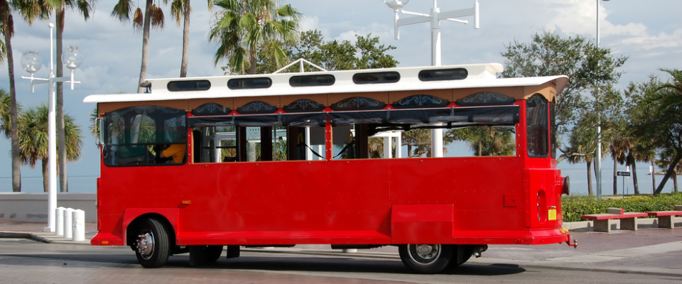 Miami’s free neighborhood trolley driving near palm trees, highlighting public transit in Miami as a convenient and affordable option for renters without cars.