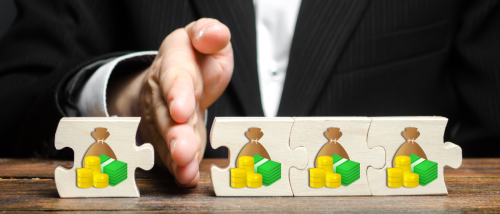 A person separating a puzzle piece with money on it from the others, signifying the process of issuing security deposit deductions.