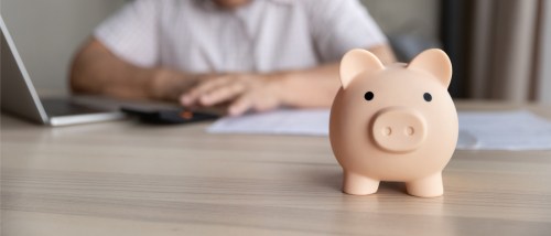 A person uses a calculator to calculate how much to pay during their rent grace period.