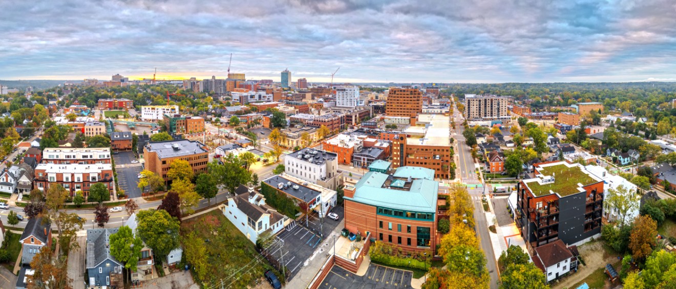 Aerial view of downtown Ann Arbor, Michigan, showing apartment buildings, residential streets, and greenery — ideal context for renters asking key questions before leasing apartments in Ann Arbor.