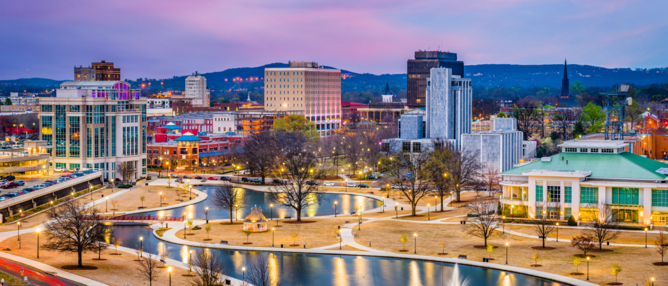 Scenic view of downtown Huntsville, Alabama, at dusk featuring Big Spring Park and city buildings — highlighting the importance of asking the right questions before renting apartments in Huntsville.