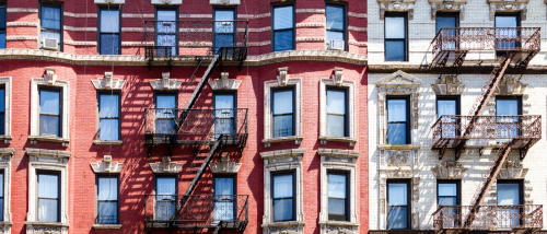An apartment building in New York with one key safety feature: fire escape stairs.
