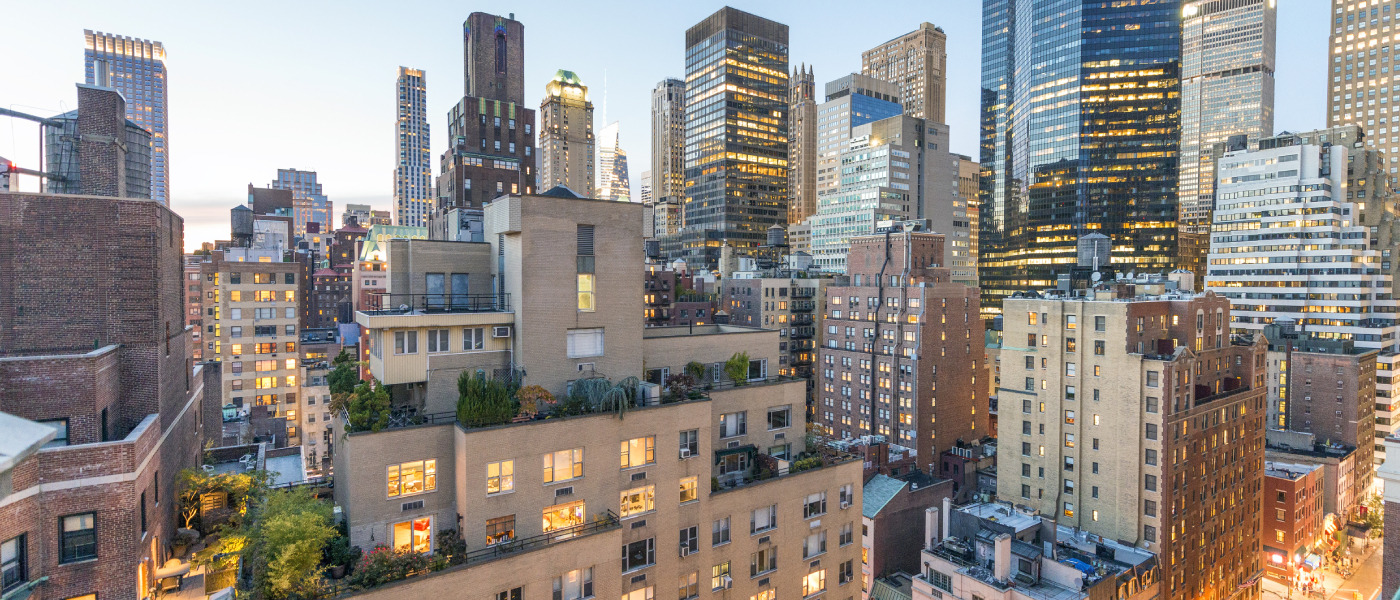 Skyline view of Manhattan apartments surrounded by modern high-rises and city lights, capturing the energy and lifestyle of downtown apartments in New York City.”