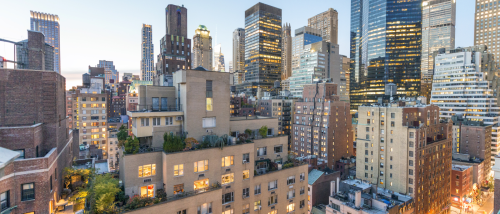 Skyline view of Manhattan apartments surrounded by modern high-rises and city lights, capturing the energy and lifestyle of downtown apartments in New York City.”