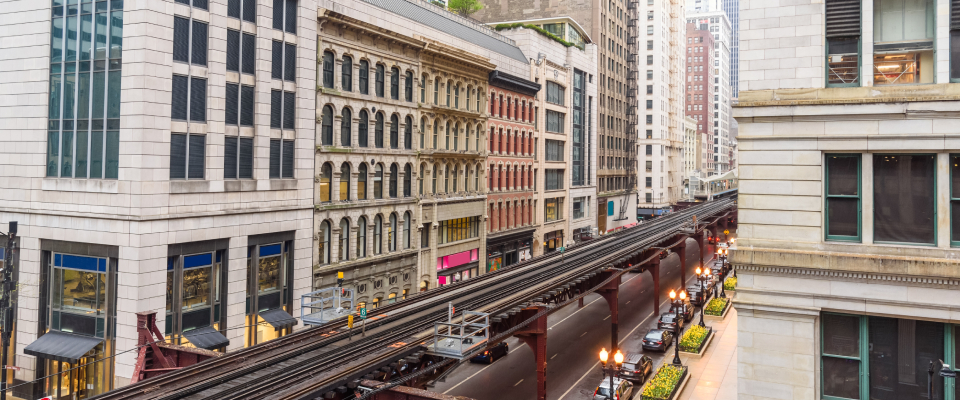 Elevated rail tracks running between buildings in downtown Chicago, highlighting easy transit access and urban living near downtown apartments.