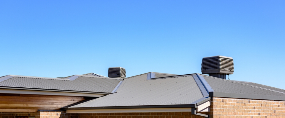 Evaporative coolers on the rooftop of an apartment building in Phoenix, Arizona, highlighting cooling systems renters should check when renting in Phoenix.
