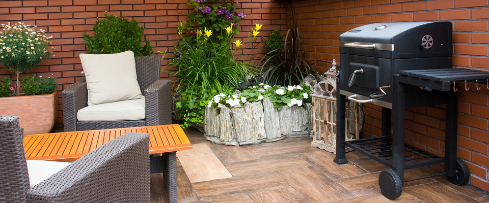 Outdoor patio with grill and seating area at an apartment building in Phoenix, Arizona, showing amenities and fire safety considerations when renting in Phoenix.