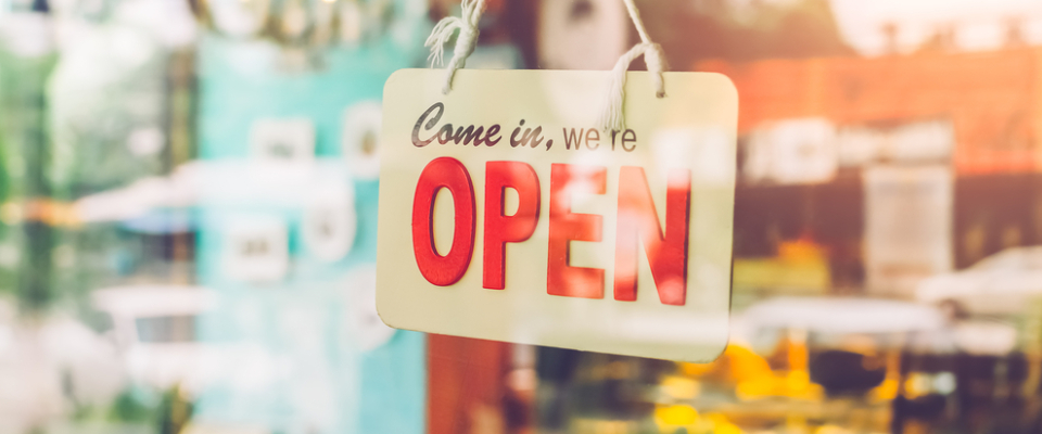 “Come in, we’re open” sign hanging on a local shop door — representing nearby amenities and community life around apartments in Ann Arbor, MI.