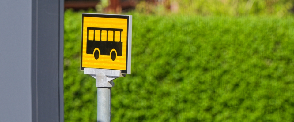 A bright yellow bus stop sign in Jacksonville, Florida, symbolizing the city’s accessible public transit and neighborhood shuttle services for renters.
