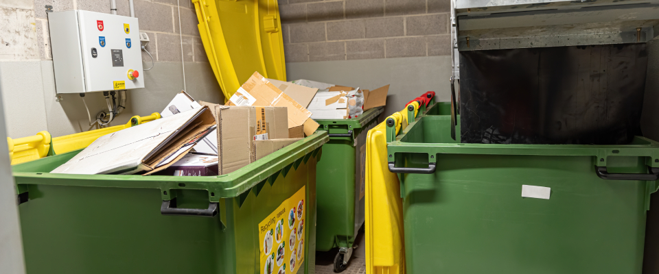 Indoor recycling and trash disposal room in an apartment building — illustrating what renters should know about garbage collection and recycling before renting apartments in Huntsville, AL.