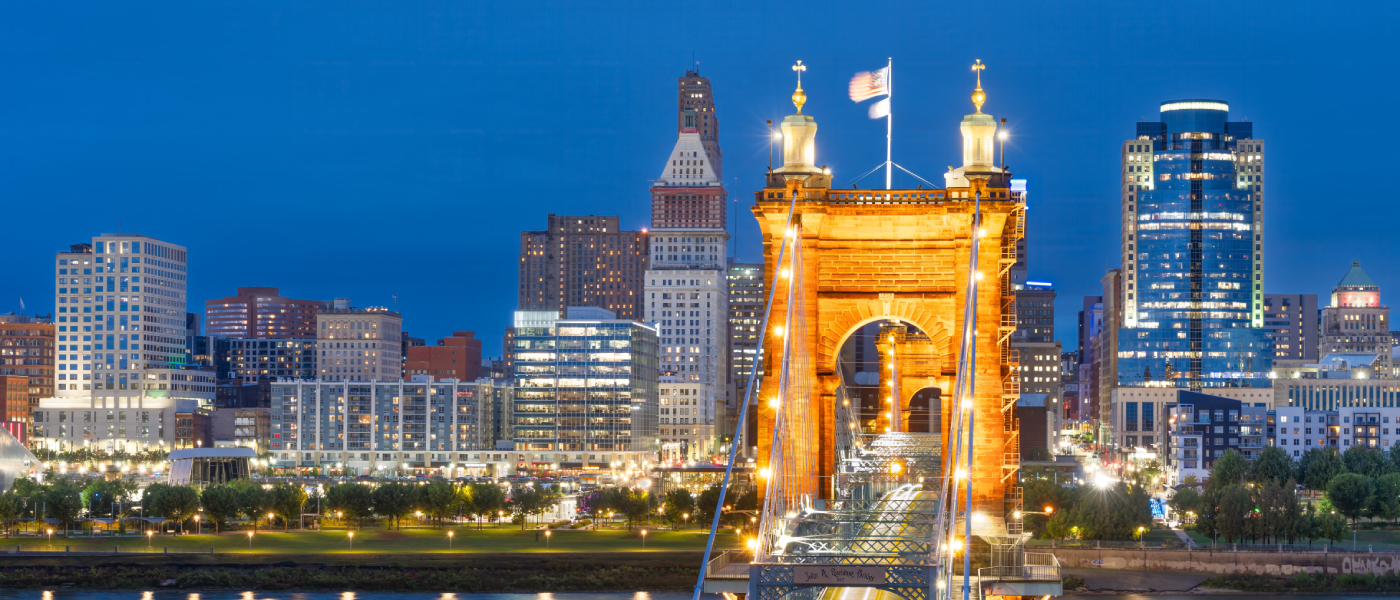 illuminated bridge against city skyline